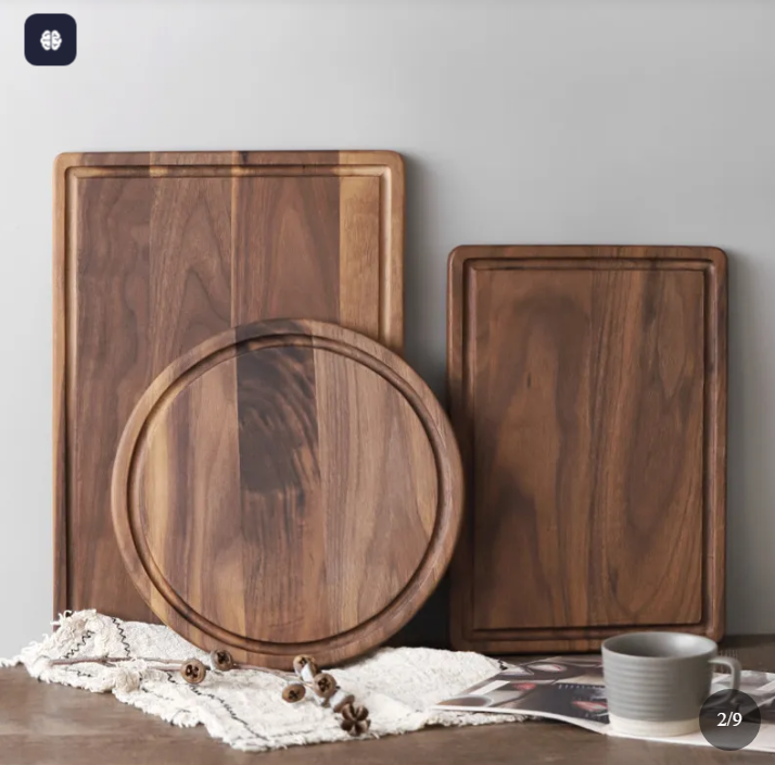 Black walnut wooden cutting boards available in round and rectangular designs.